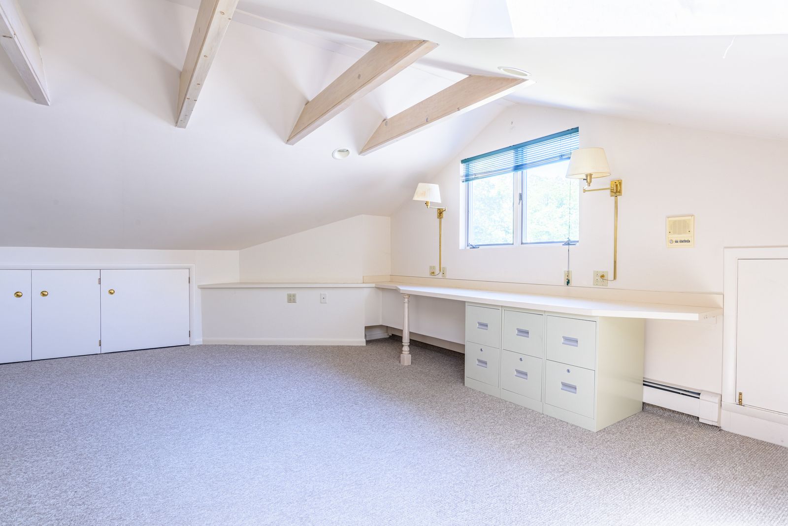 Skylit loft bonus room with built-ins