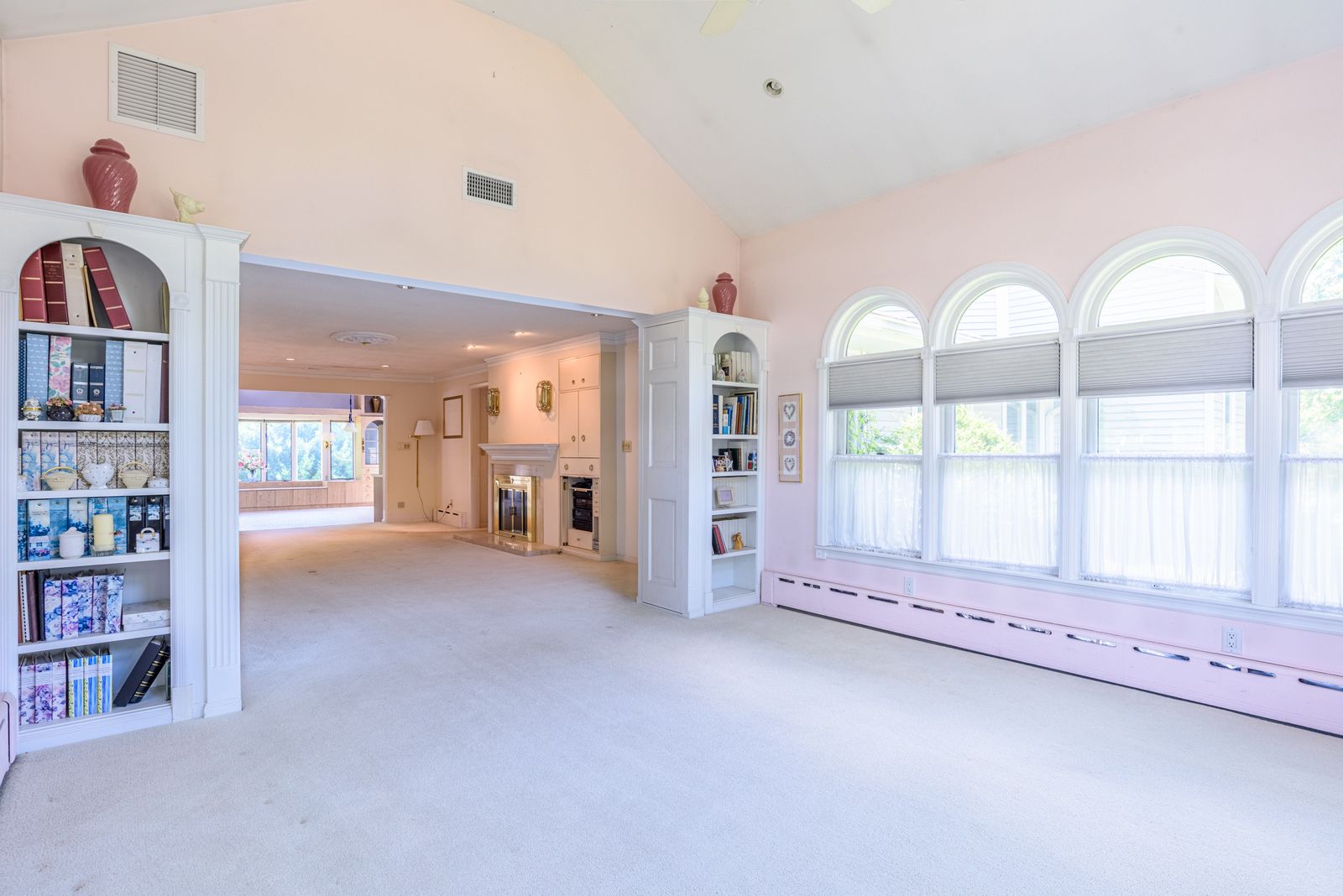 Sun room with floor-to-ceiling built-in shelving